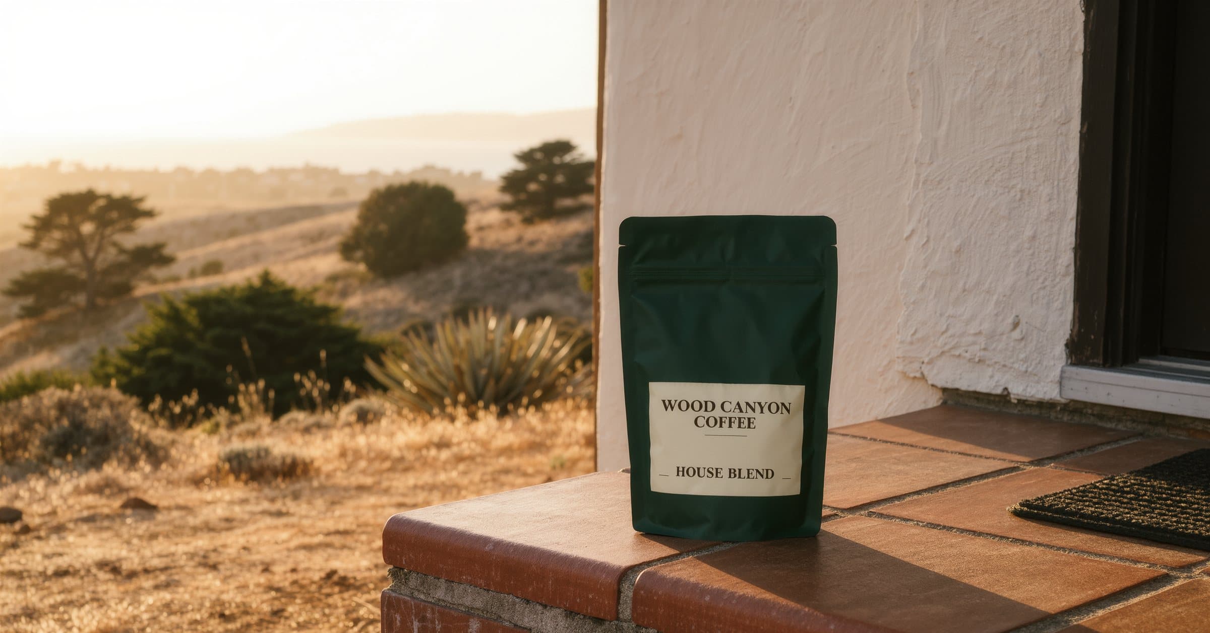 A bag of Wood Canyon Coffee house blend on a tiled front step in early morning light.