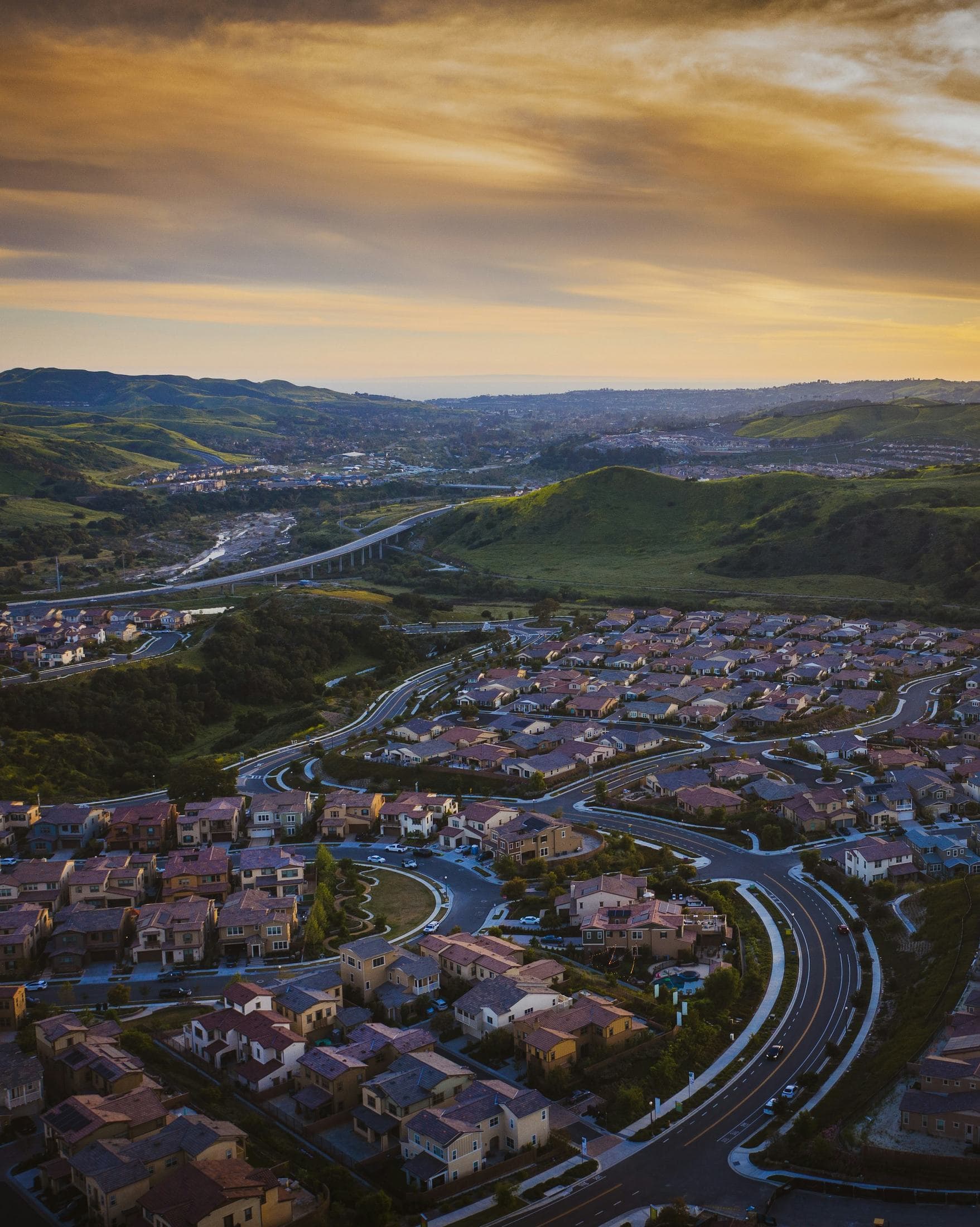 Tile roofs and hillside streets in South Orange County at first light.